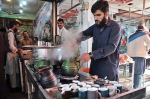 A vendor making tea for customers in a local hotel at Aabpara Market in Federal Capital