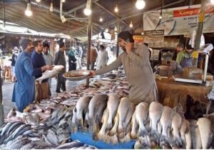 People purchasing fish from vendor in Weekly Bazaar at Peshawar Mor