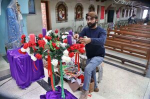 Girls decorating Christmas tree at St. Xavier Catholic Church in connection with Christmas celebration.