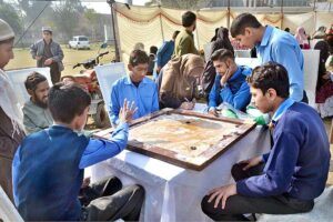 Visitor girl purchasing food items from the stall during the Special Sports Festival to mark International Day of Persons with Disabilities