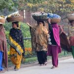 Women vendors on the way loaded with bangles on their head to deliver at Bangles market