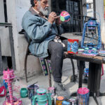 An artisan busy in painting different stuff at Ghori Town Vip Block