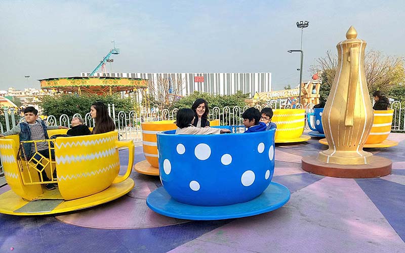 Children enjoying the mechanized swing during their winter vacations at Joyland.