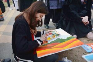 Students participating in painting competition during Chrysanthemum, Marigold & Autumn Flowers Show-2023 arranged by the Institute of Horticulture Sciences, University of Agriculture Faisalabad (UAF)