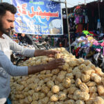 A street vendor selling traditional sweetener jaggery at his roadside setup