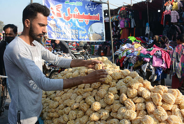 A street vendor selling traditional sweetener jaggery at his roadside setup