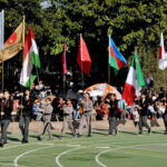 Students holding flags of different countries express solidarity with the children and people of Palestine during the annual sports day meet at the Preparatory School