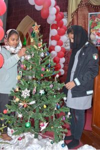 A laborer busy coloring outside grill of church in connection with upcoming Christmas