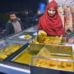 A woman sells spiced fish at Tolenton Market in Provincial Capital
