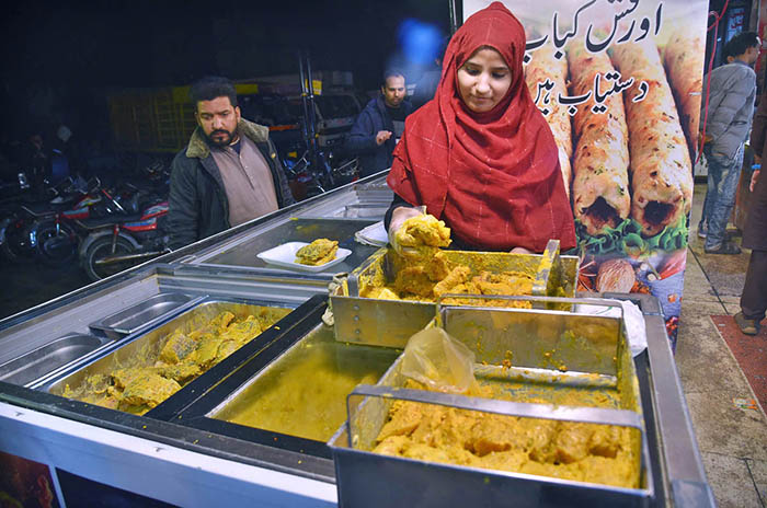 A woman sells spiced fish at Tolenton Market in Provincial Capital