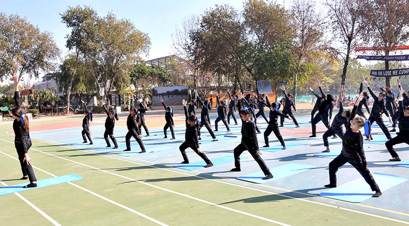 Students holding flags of different countries express solidarity with the children and people of Palestine during the annual sports day meet at the Preparatory School