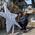 Youngsters from Christian community preparing Christmas Crib in connection with Christmas celebrations at G-7 area