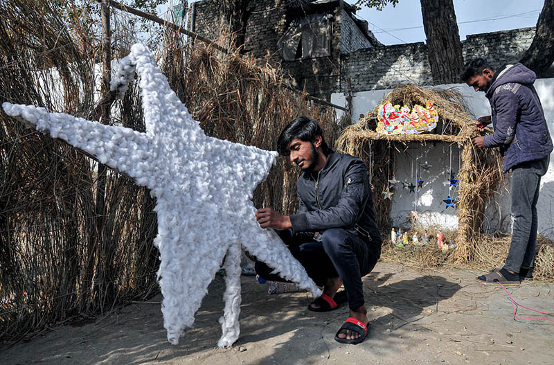 Youngsters from Christian community preparing Christmas Crib in connection with Christmas celebrations at G-7 area