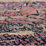 Labourer place Sindhi ajraks in sunlight for drying purpose at Tando Agha.