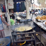 A vendor prepares Pakora for customers as per increased demand in winter.