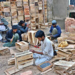 Labourers busy in preparing wooden boxes for packing fruits and vegetables at Vegetable Market