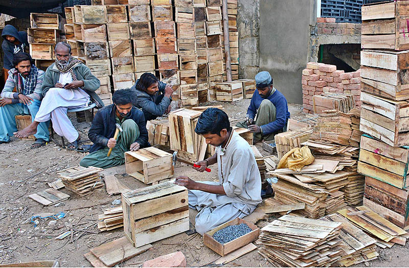 Labourers busy in preparing wooden boxes for packing fruits and vegetables at Vegetable Market