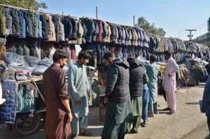 People busy in selecting and purchasing jackets from vendors at Bomb Chowk. 