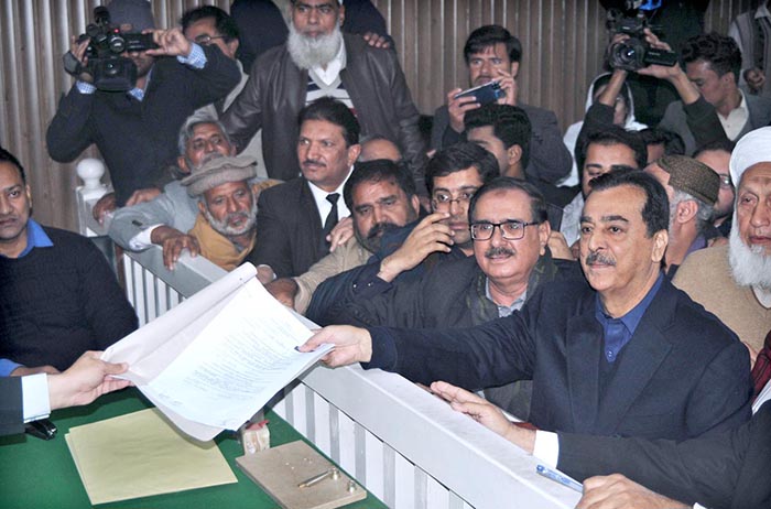 Senior Vice Chairman PPP, Syed Yousaf Raza Gillani submitting his nomination papers with his supporters at the Commissioner's office.