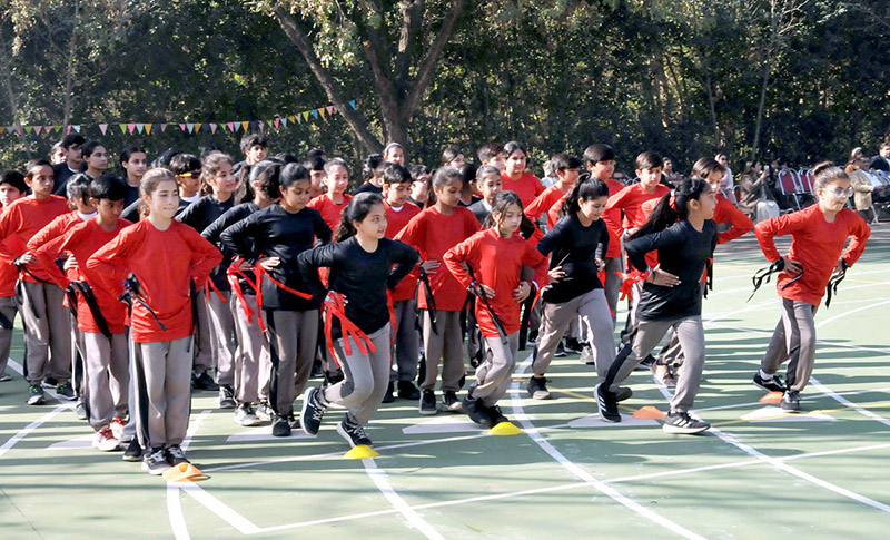 Students holding flags of different countries express solidarity with the children and people of Palestine during the annual sports day meet at the Preparatory School