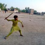 Youngster playing traditional game Guli danda
