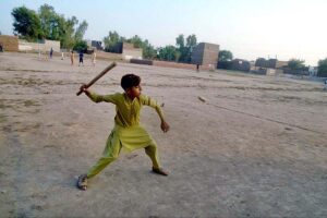 Youngster playing traditional game Guli danda