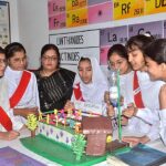 Students stand with their science project at the science fair exhibition held at Government Girls High School Junior Model
