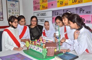 Students stand with their science project at the science fair exhibition held at Government Girls High School Junior Model