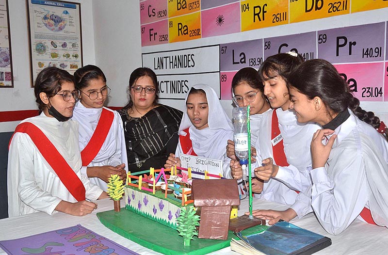 Students stand with their science project at the science fair exhibition held at Government Girls High School Junior Model