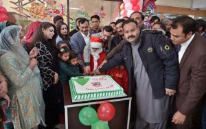 Managing Director Associated Press of Pakistan, Muhammad Asim Khichi along with Christian employees cutting cake in connection with Christmas celebrations. 