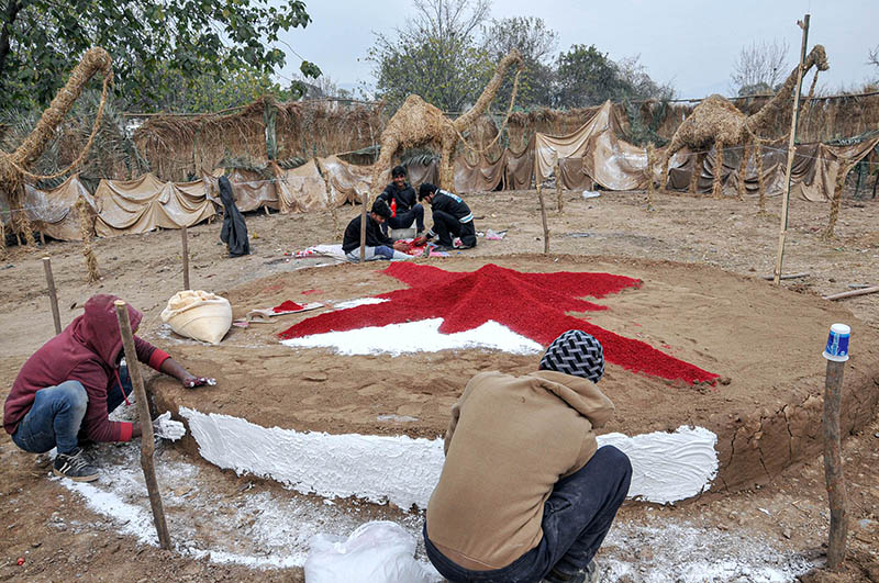 Youngsters from Christian community preparing Christmas Crib in connection with Christmas celebrations at G-7 area