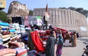 Vendor displaying blanket to attract the customer at Bacha Khan Chowk.  