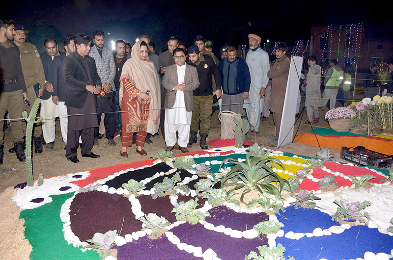 Divisional Commissioner Silwat Saeed is visiting stalls after inaugurating three days winter festival organized by the Parks and Horticultural Authority at Bagh-E-Jinnah Park on late Friday night