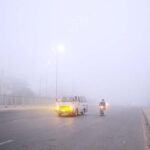Vehicles on the way during thick fog that engulfs the whole city during morning time.