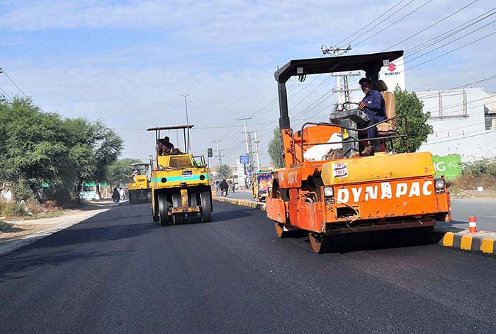 Labourers are busy in construction work of Lahore Road during development work in the city