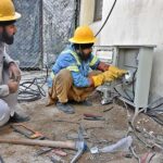IESCO workers busy installing new electricity meters in residential flats at G-7 in Federal Capital