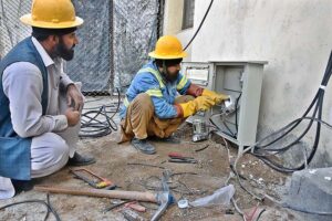 IESCO workers busy installing new electricity meters in residential flats at G-7 in Federal Capital