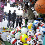 A child is interested to buy ball displayed at a stall at H-9 weekly bazar in federal capital.