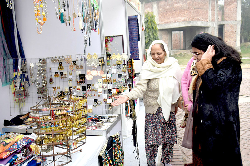 Women visiting stall during Punjab art and Culture Expo 2023 at Gaddafi Stadium