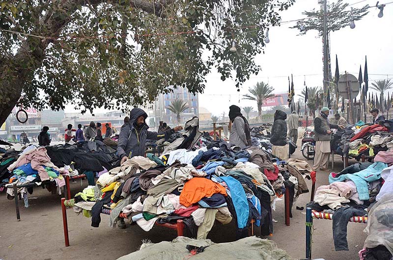 People purchasing used clothes at Landa Bazaar