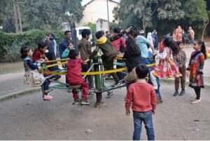 Children enjoy swings in a local park at Bagh Jinnah