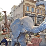 Artist using his artwork skills to restore and finalize an elephant sculpture