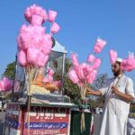A street vendor displaying traditional sweet stuff (Cotton Candy) to attract customers at Rawal Lake Park
