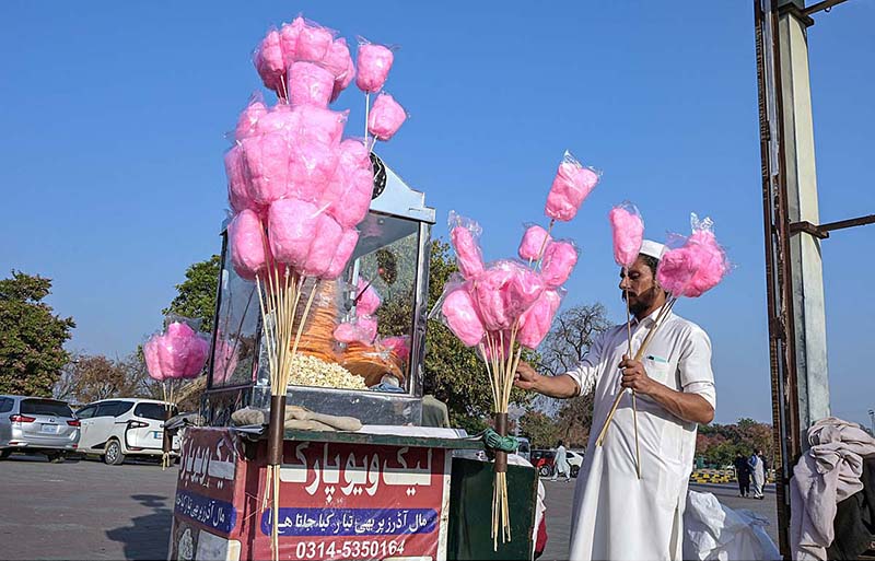 A street vendor displaying traditional sweet stuff (Cotton Candy) to attract customers at Rawal Lake Park