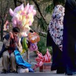 A vendor displays cotton candies and toys to attract children at the picnic spot Daman e Koh