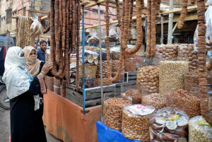 Women purchasing dry fruits from vendor at Tower Market