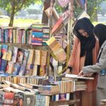 People busy in selecting and purchasing old books from roadside setup in Provincial Capital