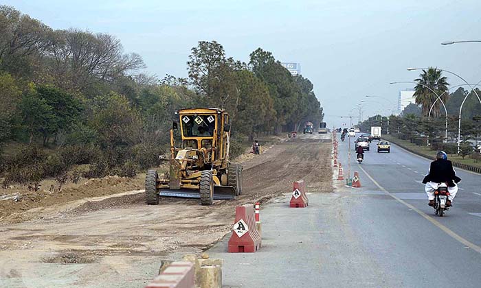 Heavy machinery being used to expand road towards F-9 Park during development work in Federal Capital.