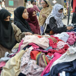 Women selecting and purchasing warm clothes at Cloth Market