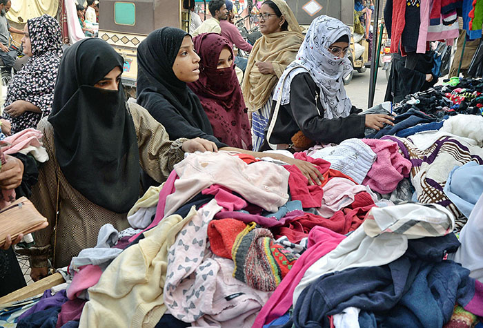 Women selecting and purchasing warm clothes at Cloth Market